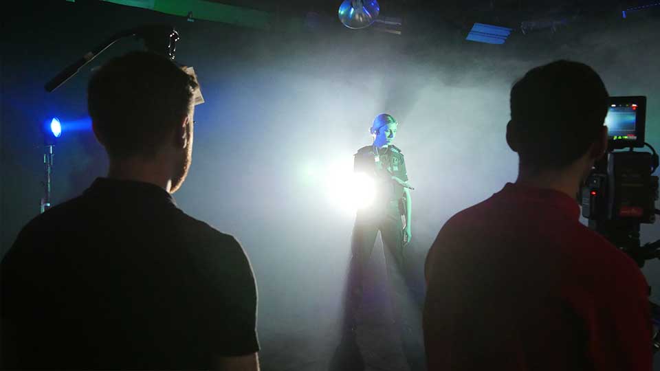 Blackout Studio Manchester A Police woman is filmed in the blacked out infinity cove studio in Manchester