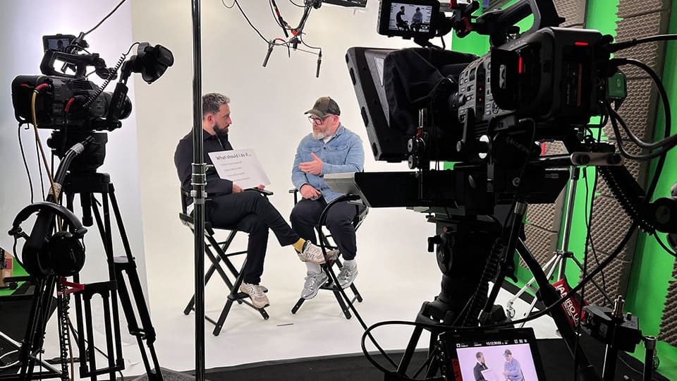 Studios For E-Learning Videos 1 Video production studio setup with two people talking.
