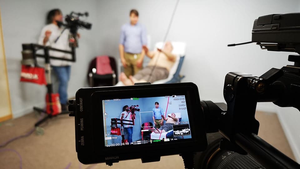 Filmmakers recording scene in a medical setting