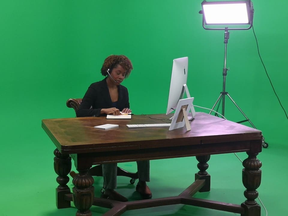 Beyond the Basics: 5 Innovative Uses for Green Screen Technology at Our Manchester Studios 8 Person working at computer in green studio