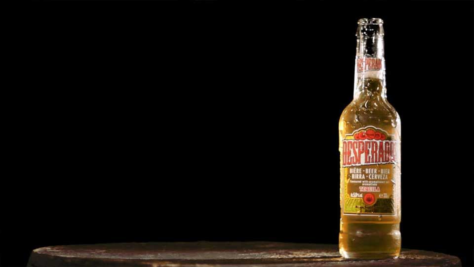 Cold refreshing beer bottle on wooden surface