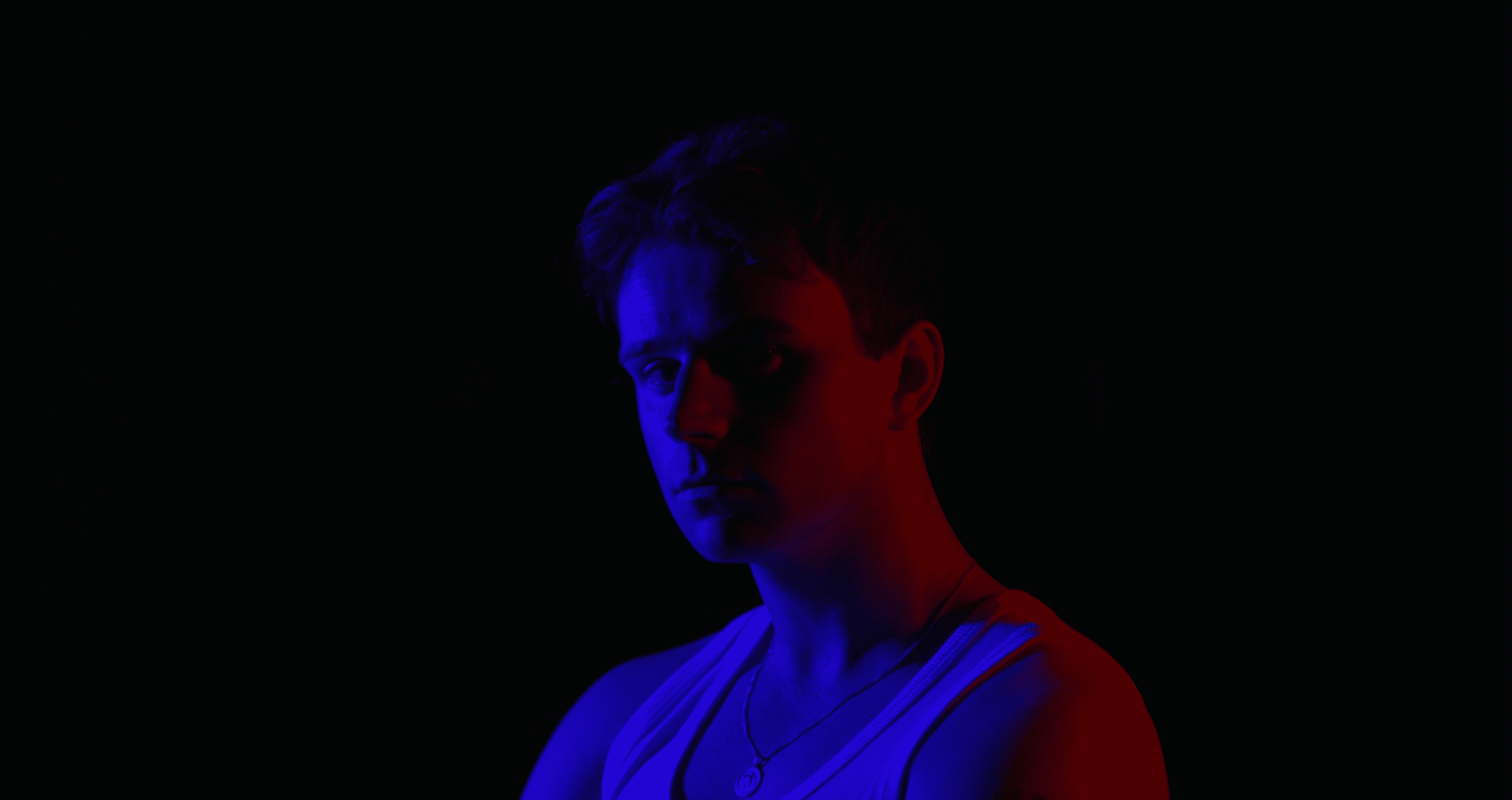 Moody portrait of person in red blue light