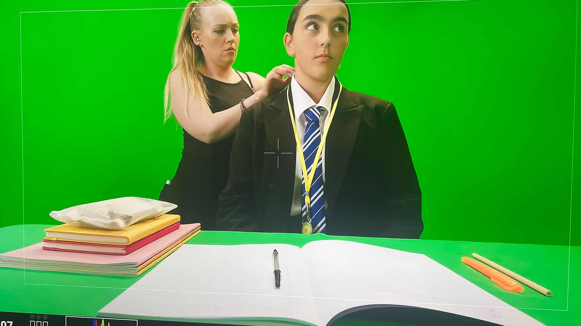 Person in suit preparing for video shoot.