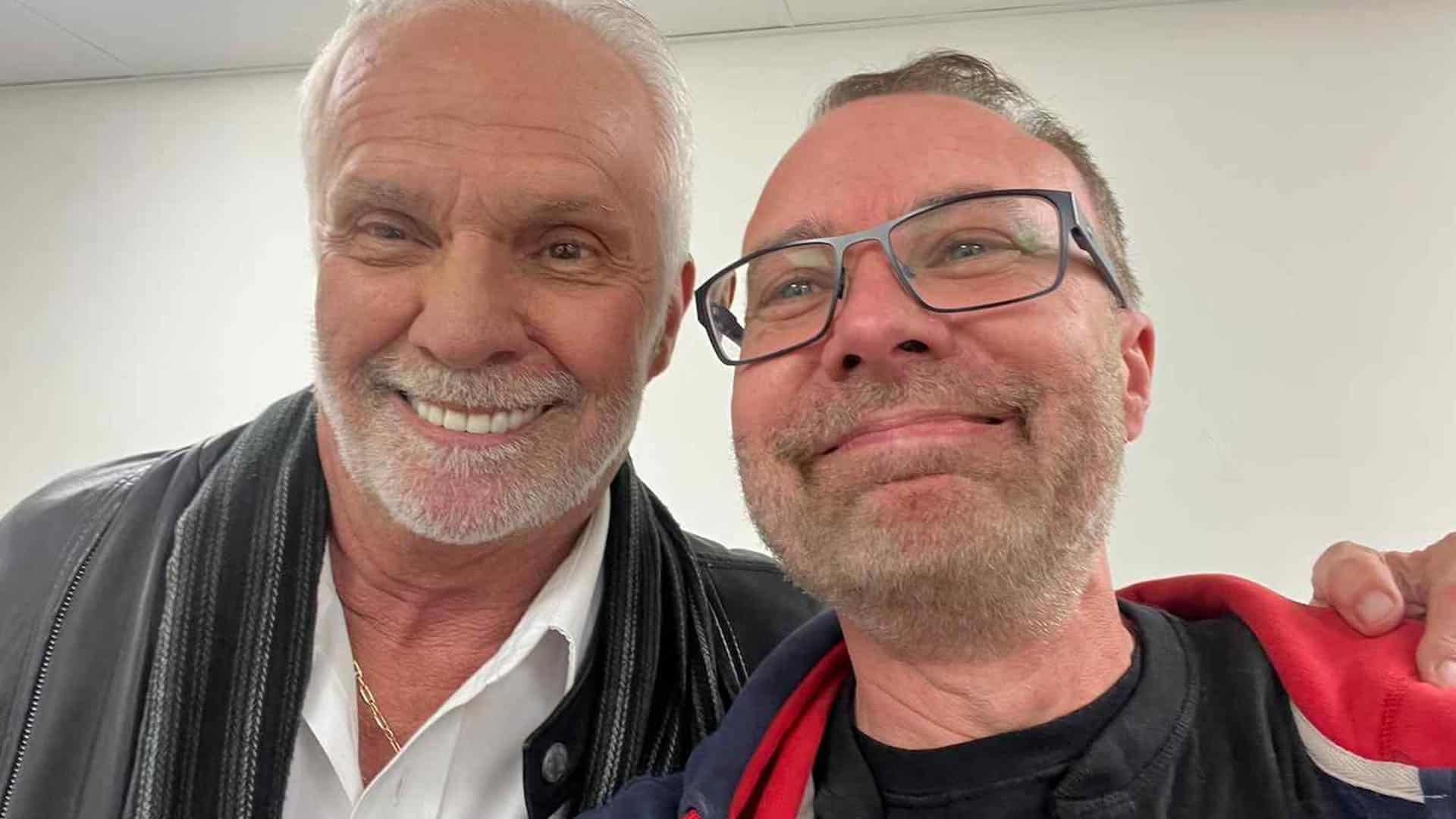 Two smiling men taking a selfie together