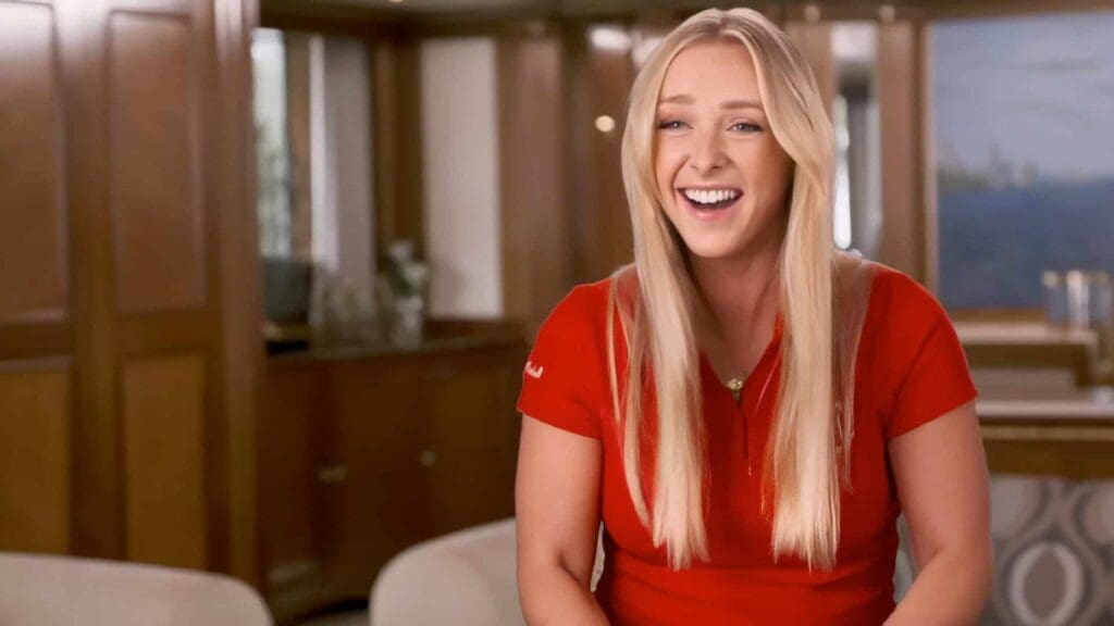 Smiling Courtney Veale in red shirt on yacht background on green screen.