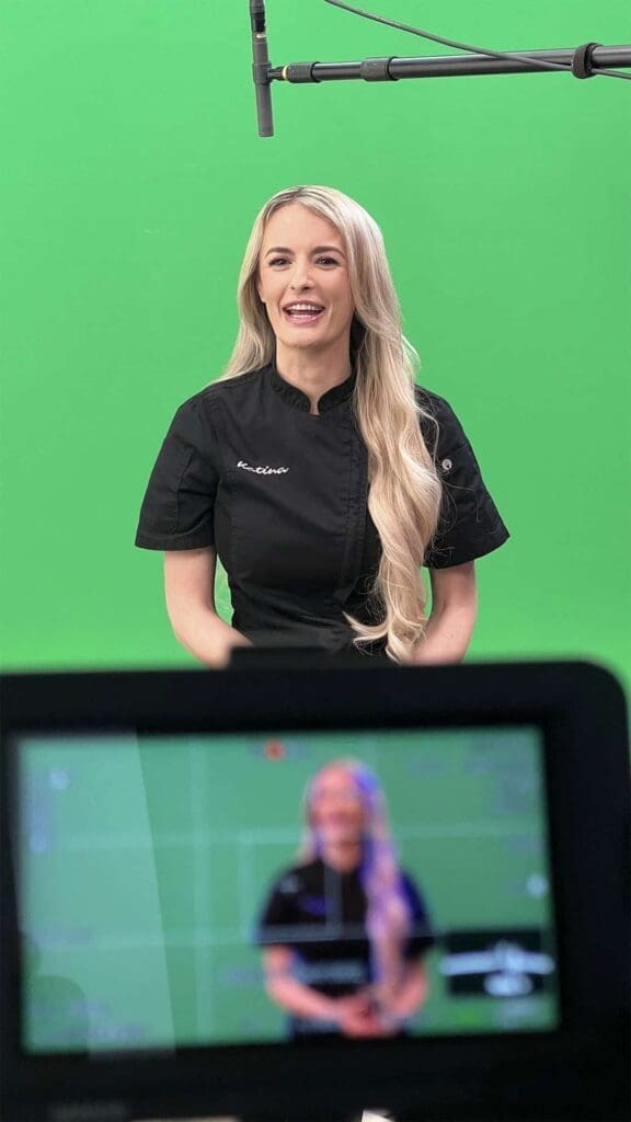 Person filming in studio with green screen at Galleon Studios