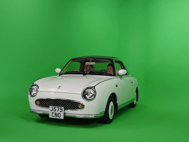 Retro white car on green screen background
