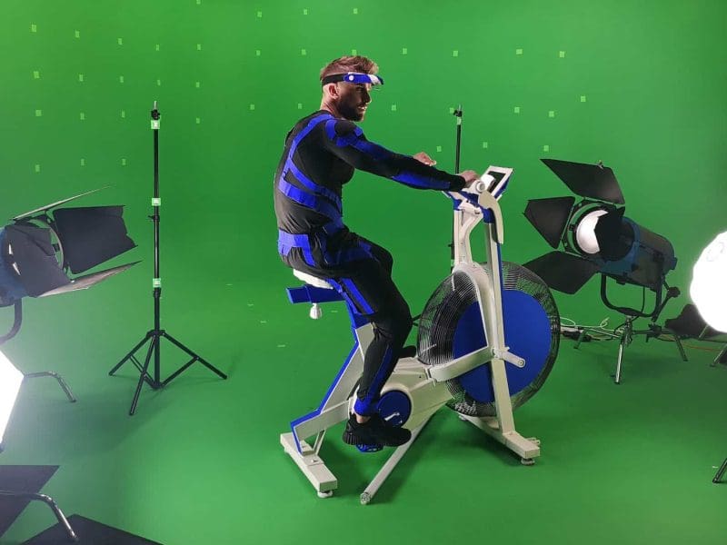 Person exercising on stationary bike in studio.