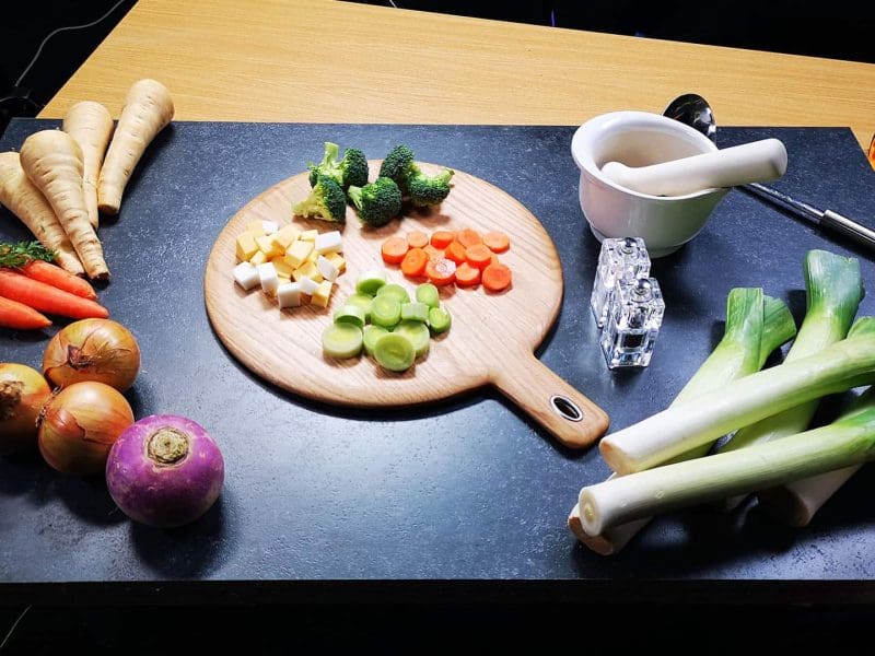 Fresh vegetables and herbs on cutting board for commercial in the studio hire in Manchester.