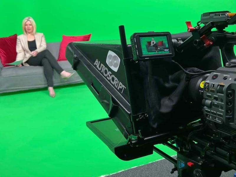 Television studio setup with green screen background and autocue